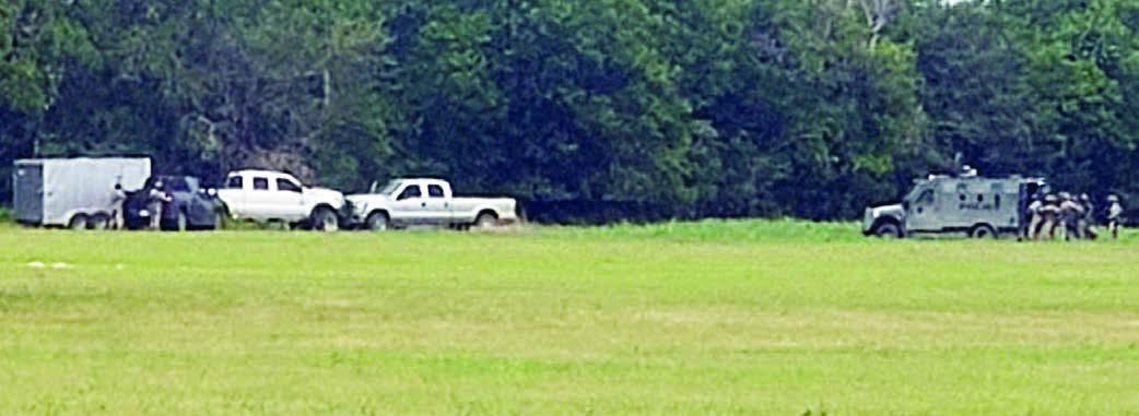 Members of the Austin County Regional Special Response Team approach the stolen vehicle and trailer. Photo Courtesy of the Fayette County Sheriff’s Department