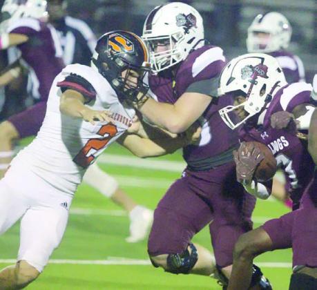 John Davis fights through a block to make a tackle in the third quarter. Sticker Photo By Darrell Vyvjala