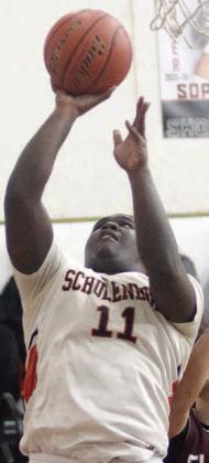 Tavondrick Ellison scores under the basket in the final period last Tuesday. Sticker Photo By Darrell Vyvjala