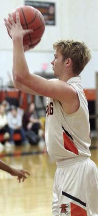 Caden Herzik hits one of his four first-half treys against Flatonia. Sticker Photo By Darrell Vyvjala