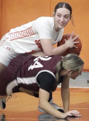Grace Schramek takes the ball away from a Lady Bulldog in the second quarter last Tuesday. Sticker Photo By Darrell Vyvjala