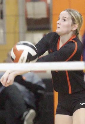 Madison Kunschick sends a pass on its way on service receive in the first set on Oct. 22. Sticker Photo By Darrell Vyvjala
