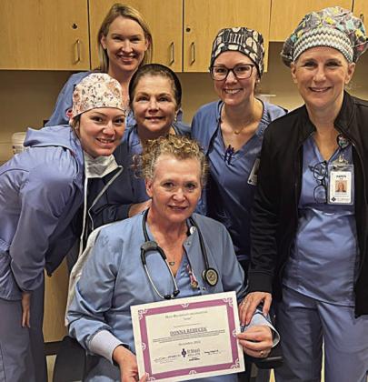 Donna Rebecek (front), BSN, RN, CEN Surgical Services, December 2022 St. Mark’s HeRO award winner, surrounded by her teammates (back, from left) Meghan Koranek, RN, Surgical Services; Jenifer Leyendecker BSN, RN, CNOR Director of Surgical Services; Geralyn Neely, BSN, RN, Surgical Services; Lensey Spradley, BSN, RN, Surgical Services; and Karen Kilian, RN, Surgical Services.