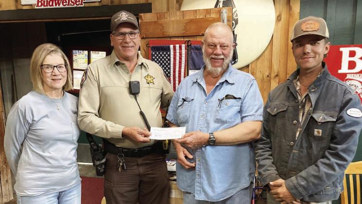 For “Make a Difference Day,” Hermann Sons Schulenburg Lodge 14 presented a monetary gift to the Fayette County Deputy Santa program. Shown are (from left) lodge vice president Mary K. Seifert, Deputy Terry Guentert, lodge president Ed Moeller and member Joshua Roberts.