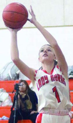 Emmrie Marx scores in the fourth quarter of the Lady Horns’ win last week. Sticker Photo By Darrell Vyvjala