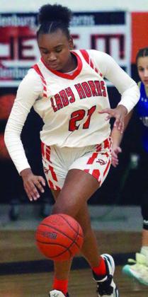 Jashiya Jackson heads up the court after stealing a Louise pass in the first half. Sticker Photo By Darrell Vyvjala