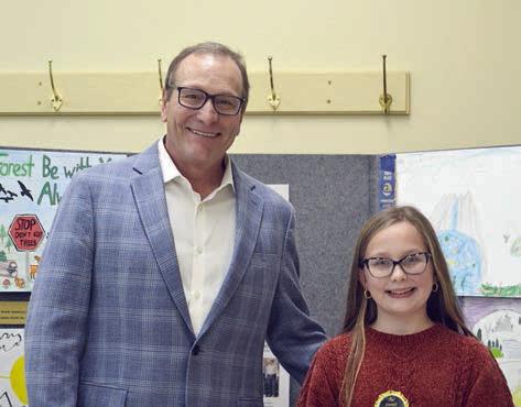 ESSAY CONTEST winners in the age 13 and under division were Charli Hadaway (right) of Sacred Heart School in La Grange and Bree Dooley (not shown) of Round Top-Carmine High School. Presenter was Tim Knesek (left) of Capitol Farm Credit.