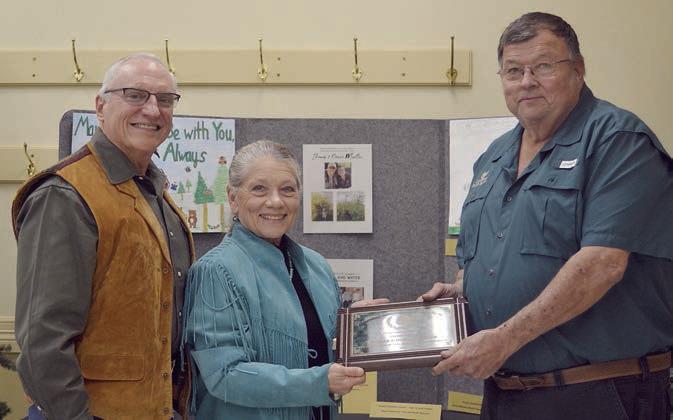 The CONSERVATION RANCHER awar d went to Dr. Thomas and Donna Mueller (left, center) Presenter was Roy Wied of Carmine State Bank (right).