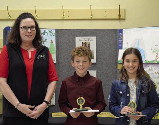 POSTER CONTEST winners in Division 2 (grades 3-6) were Carter Weyand (center) of Round Top-Carmine Elementary and Brielle Goedrich (right) St. Rose of Lima Catholic School in Schulenburg. Presenter was Tracy Denton (left) of Fayette Electric Cooperative.