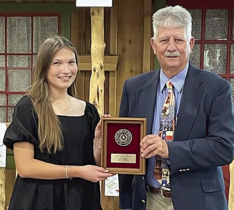 ELL A PINED A (left) of La Grange received a plaque for placing second in the essay contest held as part of the Texas Conservation Awards Program. The presenter was Leroy Wolff (right), Area 3 director for the Association of Texas Soil &amp;amp; Water Conservation Districts (ATSWCD).