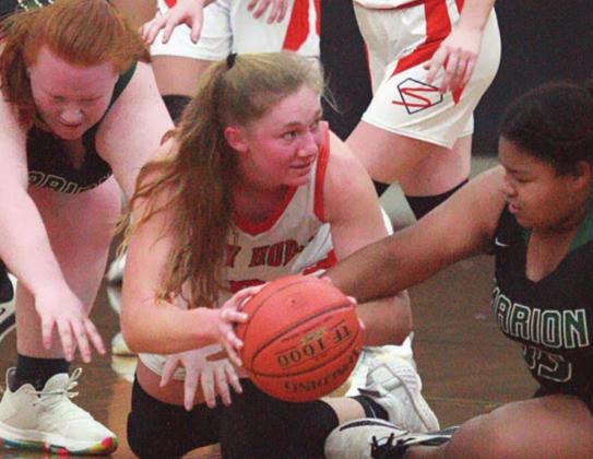 Erica Otto forces a Marian turnover in the second quarter of last Friday’s season opener. Sticker Photo By Darrell Vyvjala