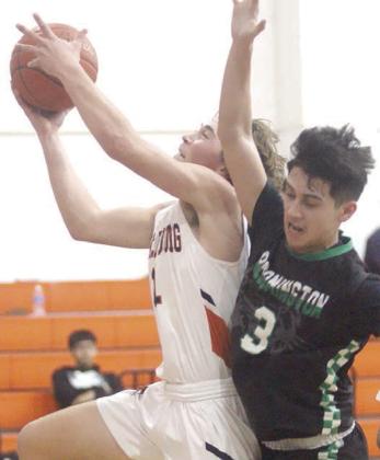 Jayse Janda takes a bump and scores before making a free throw to complete a three-point play against Bloomington. Sticker Photo By Darrell Vyvjala