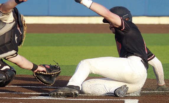 Jayse Janda beats the tag on his steal of home in game two. Sticker Photo By Darrell Vyvjala