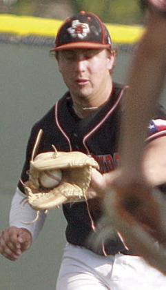 Third baseman Tyson Wagner gloves a grounder late in game one. Sticker Photo By Darrell Vyvjala