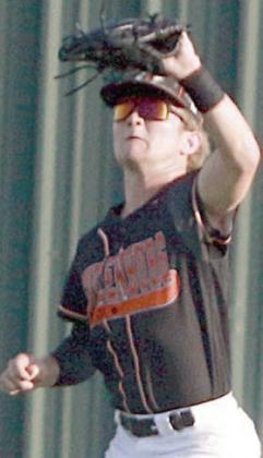 Brycen Schramek secures a fly ball in left field early in game three. Sticker Photo By Darrell Vyvjala