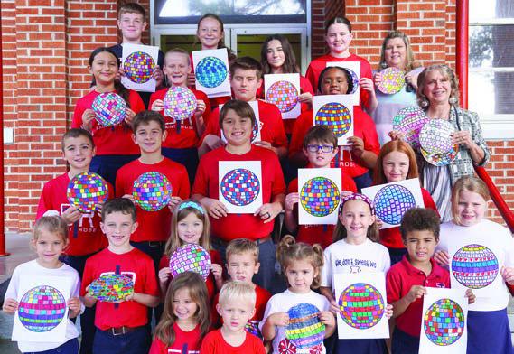 A disco ball theme helped promote the Parents As Teachers Day observance, and area students were asked to decorate disco ball artwork. Shown are St. Rose of Lima Catholic School students displaying their creations.