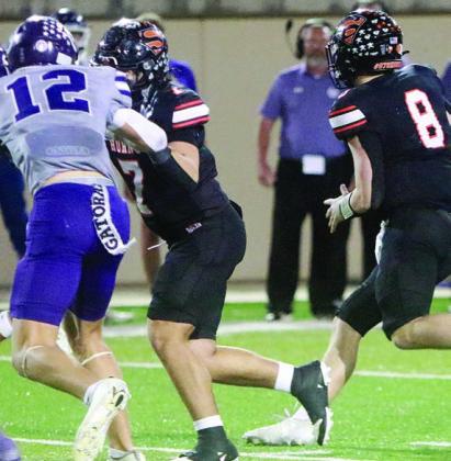 Landon Conner (left) springs Owen Brenek with his block on a 17-yard run in the third quarter. Sticker Photo By Layne Vyvjala