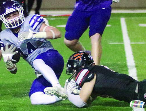 Emerson Harvey trips up Christian Gammill for a loss of 2 in the fourth quarter. Sticker Photo By Layne Vyvjala