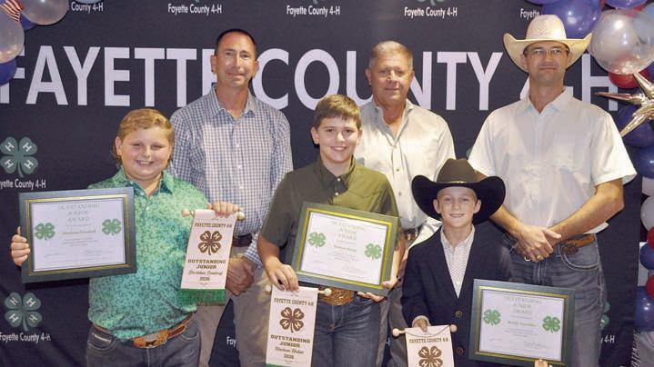 Outstanding Juniors – (front row, from left) Stockton Emshoff, Hudson Holub and Rowdy Guenther. Presenters (back row, from left) Commissioners Jason McBroom, Harvey Berckenhoff and Clint Sternadel.