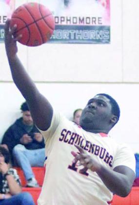 Tavondrick Ellison drives to the basket for a layup in the opening period. Sticker Photo By Darrell Vyvjala