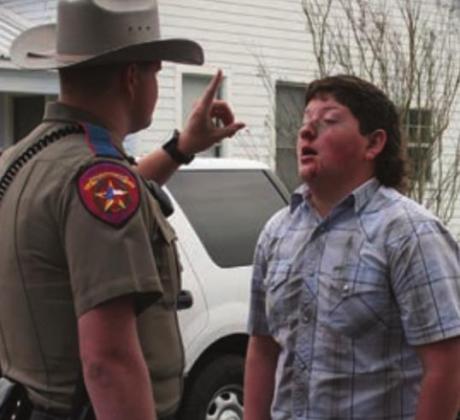 Ethan Steinhauser receives a field sobriety test from a trooper. Sticker Photo By Darrell Vyvjala
