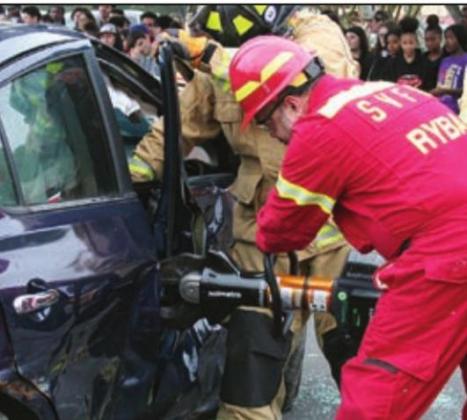 Firefighter Ronald Ryba extricates a victim. Sticker Photo By Darrell Vyvjala