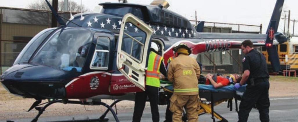 Kaz McBride gets loaded into the Air-Evac helicopter for transport. Sticker Photo By Darrell Vyvjala
