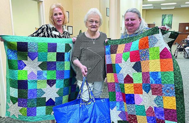 Charity quilts DONAT ed – Bobbie Elliott (center) represented the Colorado Valley Quilt Guild in giving 10 quilts to Columbus Oaks HealthCare Community, represented by Dawn Raymond (left) and Amy Stancik (right).