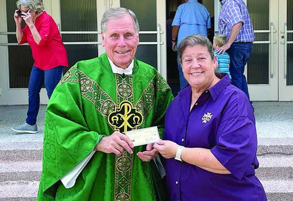 Catholic Daughters of the Americas, Court St. Rose 1597, has made a donation toward new rugs for the entrance to St. Rose of Lima Catholic Church. Donations were also received from the St. RoseAltar Society and Knights of Columbus Council 2902. Grace Lebeda (right), regent, represents Court St. Rose in presenting the check to Fr. Jasper Liggio (left), St. Rose pastor.