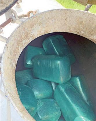Drug Interdiction Investigator David Smith (shown in photo at right) located bundles of marijuana weighing 350 pounds in the cleaning tank (above) of a septic cleaning truck during a traffic stop on I-10 near Flatonia.