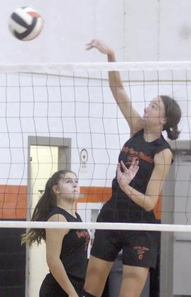 Meredith Magliolo hammers down a set from Landry Zapalac during pre-season workouts last week. The two are among four returning all-state selections for the Lady Horns this season. Sticker Photo By Darrell Vyvjala