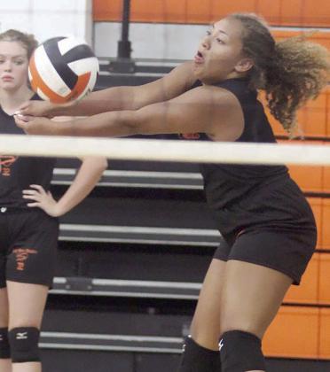 Senior Kieryn Adams gets a dig during practice drills. The all-state selection returns as the team’s leader in digs and aces. Sticker Photo By Darrell Vyvjala