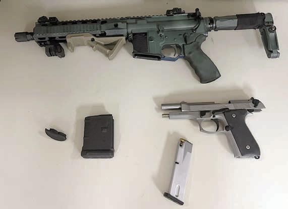 A 9mm Beretta handgun and an AM-15 rifle were retrieved during the incident in which the suspect pointed the handgun at a deputy.