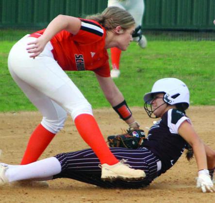 Hailey Kahlden tags out a Lady Bulldog at third base. Sticker Photo By Darrell Vyvjala