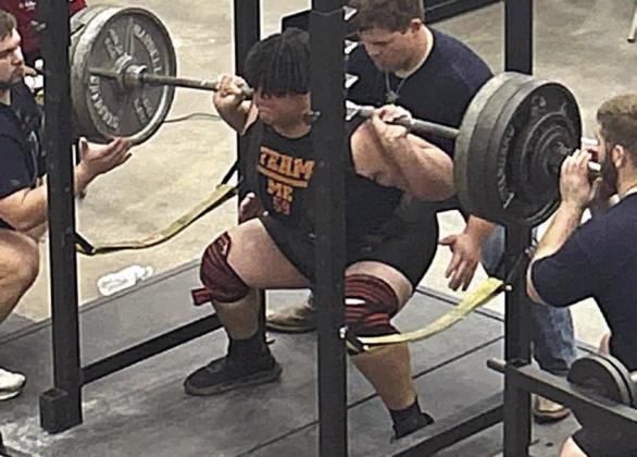 Calvin Thompson sets a personal best in the squat by pushing up 600 pounds at the state meet.