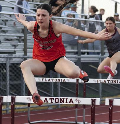 Ava Faith on her way to first place in the 100-meter hurdles. Photo By Melanie Berger / Courtesy of Flatonia Argus