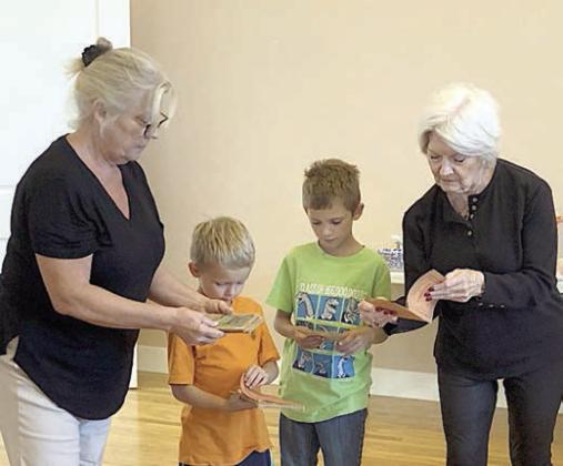 An ancest or’s Czech books of pl ays were brought by Dominik Woodworth (second from left) and Zander Woodworth (second from right) along with their grandmother Taffy Danner (left) and greatgrandmother Betty Danner (right).