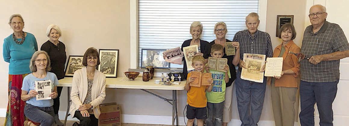 A special show-and-tell at the Fayette County Czech Heritage Society fall meeting featured personal stories and meaningful relics. Shown with the many items brought are (front row, from left) Marilyn Cernoch, Barbara Eilert, Dominik Woodworth, Zander Woodworth, (back row) Rebecca Hager, Betty Danner, Kathie Craft, Taffy Danner, Billy Teague, Phyllis Teykl and Tom Teykl.