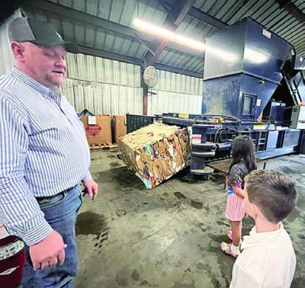 Recycling manager Paul Zapalac briefs the Science Club on the recycling center in the photo at left and in the photo at right Zapalac speaks to Cason Hale (foreground).