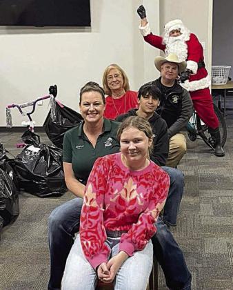 Shown during last year’s Deputy Santa Program toy distribution in Schulenburg are: (front to back) Emilie Fowler, Sgt. Angela Lala, Jesse Pardo, Nettie Cernosek, Investigator Kenn Kretz, and Santa (Deputy Jason Fowler).
