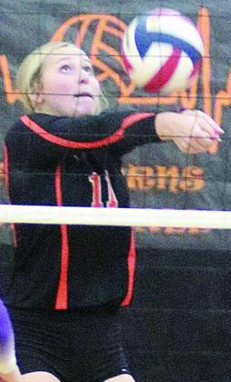 Saybra Pinney saves a ball near the net in the first match last Tuesday. Sticker Photo By Darrell Vyvjala