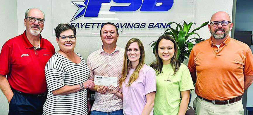 Fayette Savings Bank and Led + Fed representatives on hand for the donation presentation were (from left) Mike Olle and Cheryl Brossmann, FSB; Nathan and Jenny Neiser, Led + Fed founders; Alycia Konvicka, Led + Fed board member; and Brad Tumis, FSB.