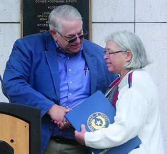 REP. KITZMAN VISITS – State  Rep. Stan Kitzman presents Mayor Connie Koopmann with his congratulatory  resolution after speaking. Sticker Photo By Darrell Vyvjala