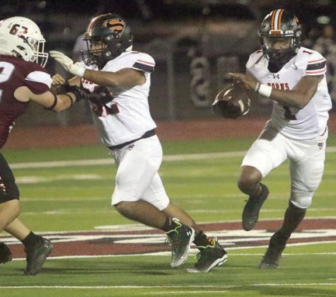 Austin Toro (left) clears the way for a Da’Terrion Houston run in the second quarter. Sticker Photo By Layne Vyvjala