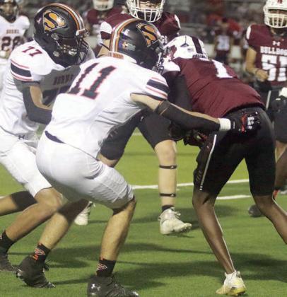 Nick Goode (No. 11) and Jayden Olmos drop Keegan Green for a loss of 5 in the fourth quarter. Sticker Photo By Darrell Vyvjala