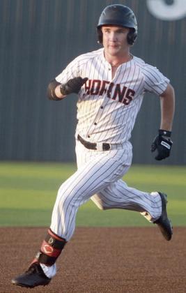 Brycen Schramek rounds second on his way to a triple in game one. Sticker Photo By Darrell Vyvjala