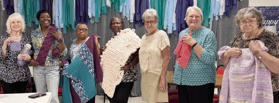 In the Artful Friday crochet class, led by Sheryl Tumis, those showing off their projects at the last class include (from left) Kim Penland, Deborah Jones, Janice Collins, Frida Ellison, Sheryl Tumis, Joan Ulrich and Leona Lange.