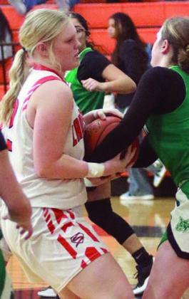 Ava Bubela battles a Lady Bobcat for a loose ball in the third quarter. Sticker Photo By Darrell Vyvjala