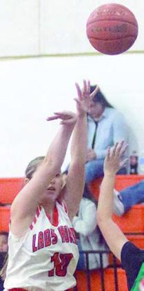 Gracie Burton releases a threepointer against Bloomington. Sticker Photo By Darrell Vyvjala