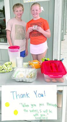 Kase Bubela (left) and Chandler Bubela (right) held bake sales in front of Anytime Fitness to raise funds for Hill Country flood victims.